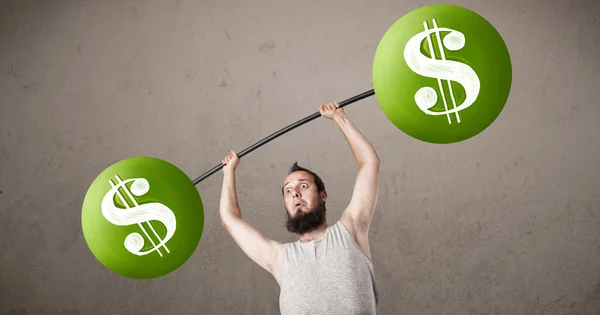 Skinny guy lifting green dollar sign weights — Stock Photo, Image