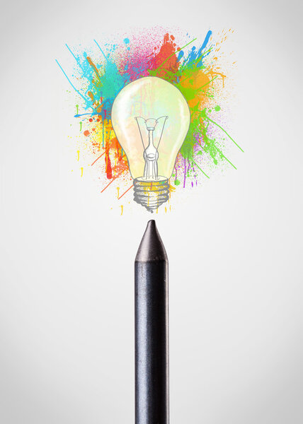 Crayon close-up with colored paint splashes and lightbulb