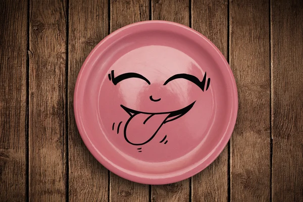 Happy smiley cartoon face on colorful dish plate — Stock Photo, Image