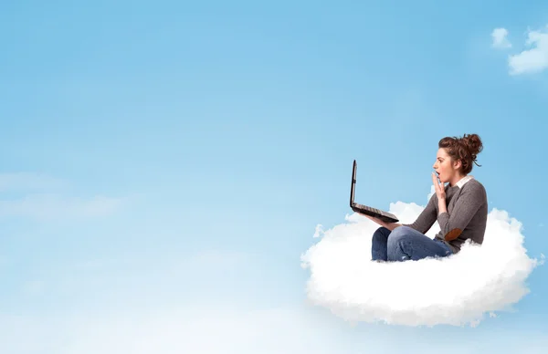 Young woman with laptop sitting on cloud with copy space — Stock Photo, Image