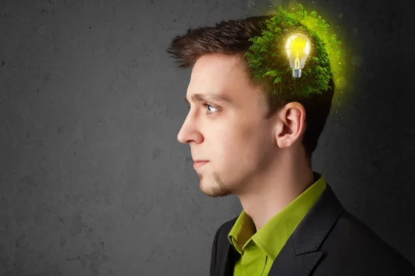 Young mind thinking of green eco energy with lightbulb — Stock Photo, Image