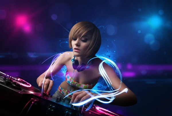 Disc jockey playing music with electro light effects and lights — Stock Photo, Image