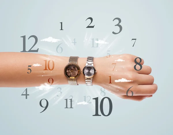 Hand with watch and numbers on the side comming out — Stock Photo, Image