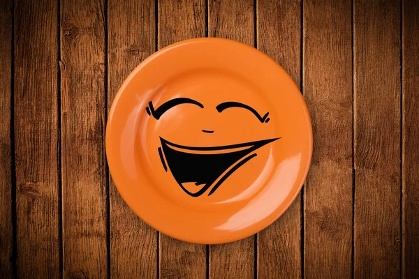 Cara de dibujos animados sonriente feliz en plato colorido — Foto de Stock
