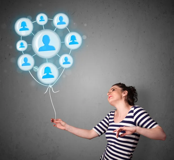 Woman holding social network balloon — Stock Photo, Image