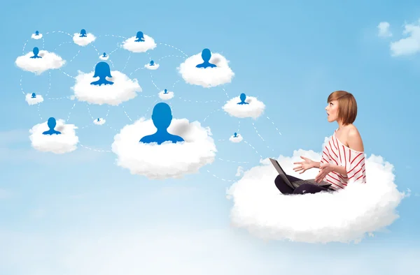 Young woman sitting in cloud with laptop — Stock Photo, Image