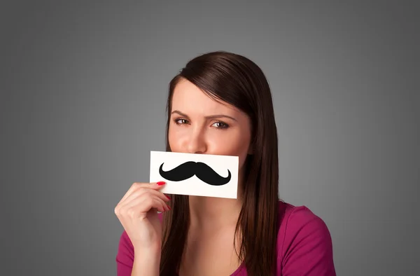 Feliz linda chica sosteniendo papel con bigote dibujo — Foto de Stock