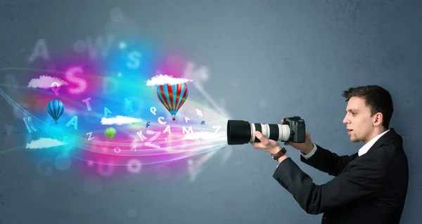 Handsome photographer with camera and abstract imaginary — Stock Photo, Image