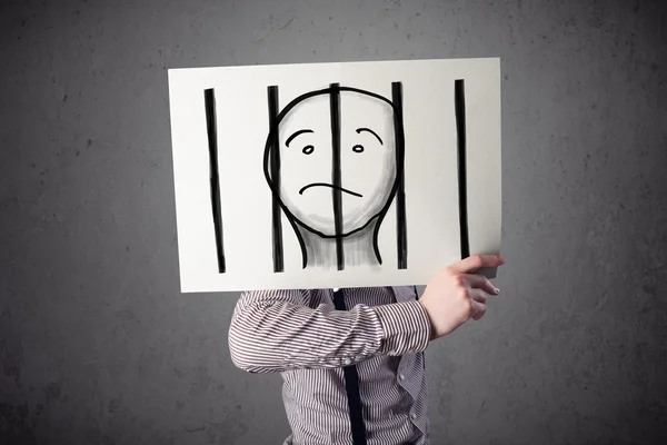 Businessman holding a paper with a prisoner behind the bars on i — Stock Photo, Image