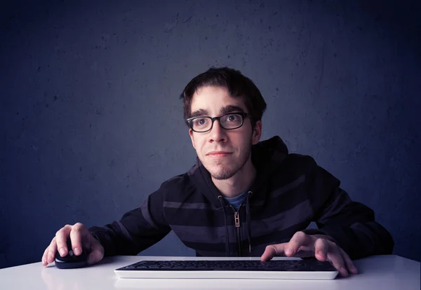 Hacker working with keyboard on blue background — Stock Photo, Image