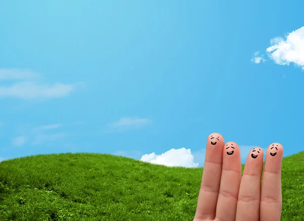 Cheerful finger smileys with landscape scenery at the background — Stock Photo, Image