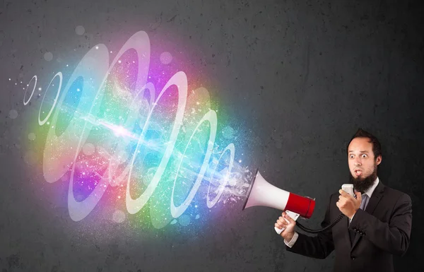 Man yells into a loudspeaker and colorful energy beam comes out — Stock Photo, Image