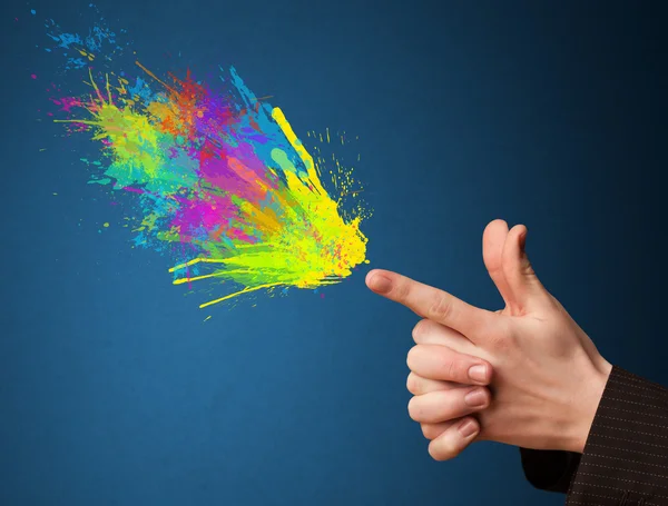 Colorful splashes are coming out of gun shaped hands — Stock Photo, Image