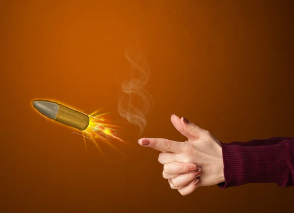 Gun shaped woman hand with bullet — Stock Photo, Image