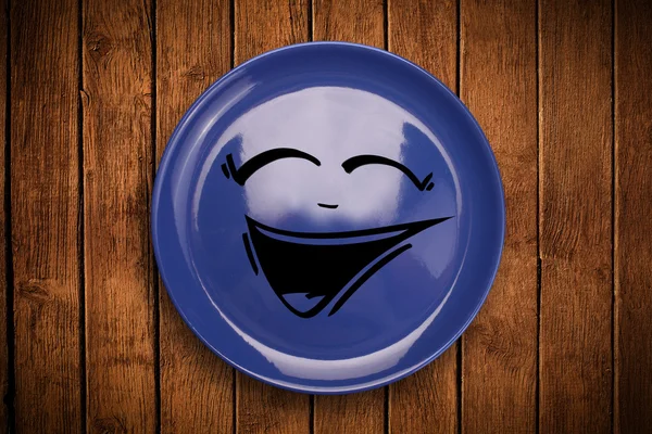 Happy smiley cartoon face on colorful dish plate — Stock Photo, Image