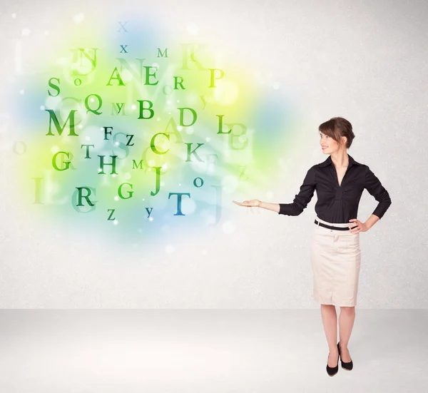 Business women with glowing letter concept — Stock Photo, Image