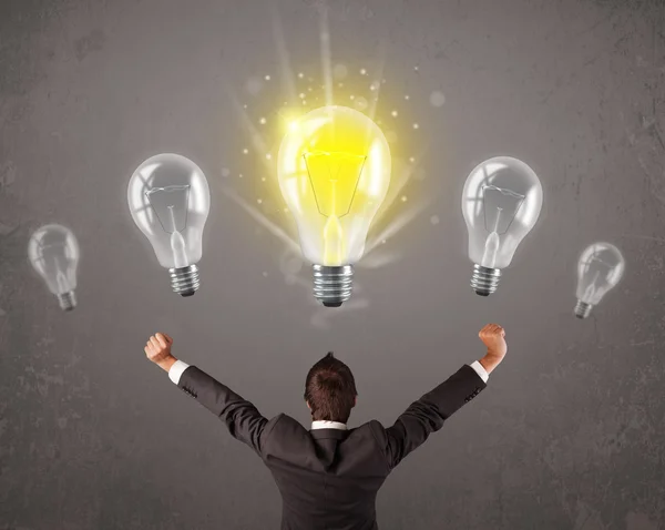 Business person having an idea light bulb concept Stock Image