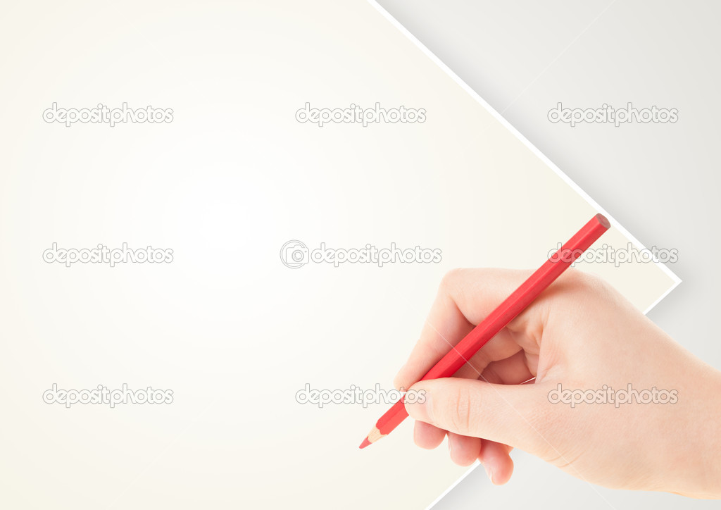 Human hand drawing with pencil on empty paper template