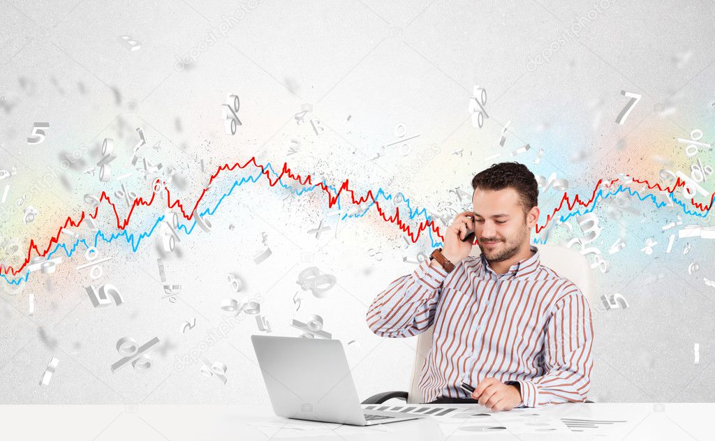 Business man sitting at table with stock market graph 