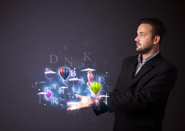 Letters and balloons in the hand of a businessman — Stock Photo, Image