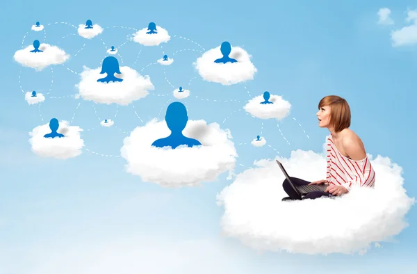 Young woman sitting in cloud with laptop — Stock Photo, Image