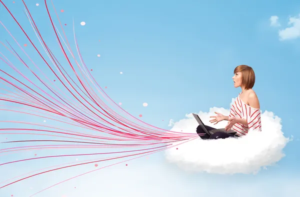 Young woman sitting in cloud with laptop — Stock Photo, Image