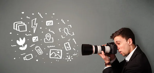 Photographer boy capturing white photography icons and symbols — Stock Photo, Image