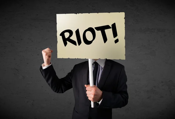 Businessman holding a protest sign — Stock Photo, Image