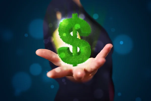 Young woman presenting green glowing dollar sign — Stock Photo, Image