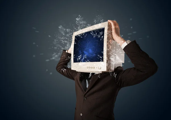 Computer monitor screen exploding on a young persons head — Stock Photo, Image