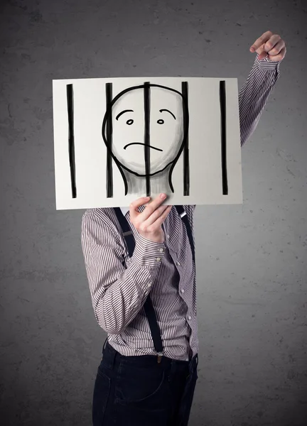 Businessman holding a paper with a prisoner behind the bars on i — Stock Photo, Image