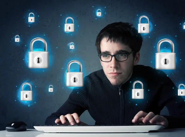 Young hacker with virtual lock symbols and icons — Stock Photo, Image