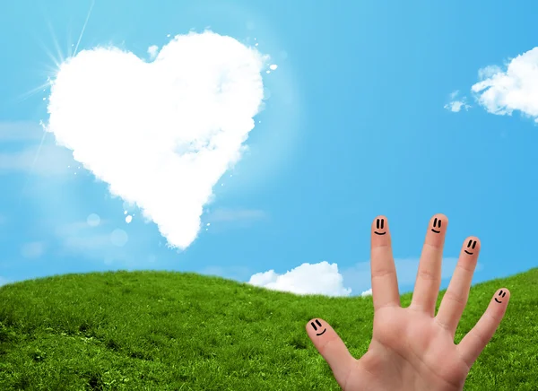 Szczęśliwe uśmiechnięte palce patrząc na chmurę w kształcie serca — Zdjęcie stockowe