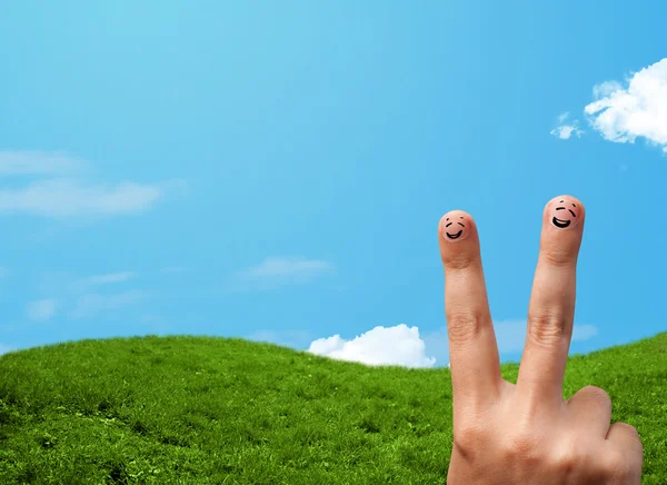 Cheerful finger smileys with landscape scenery at the background — Stock Photo, Image