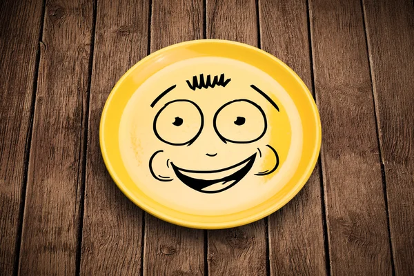 Happy smiley visage de dessin animé sur plaque de plat coloré — Photo