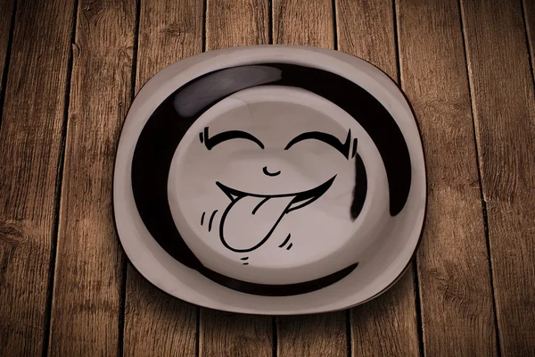 Cara de desenho animado sorridente feliz no prato colorido — Fotografia de Stock