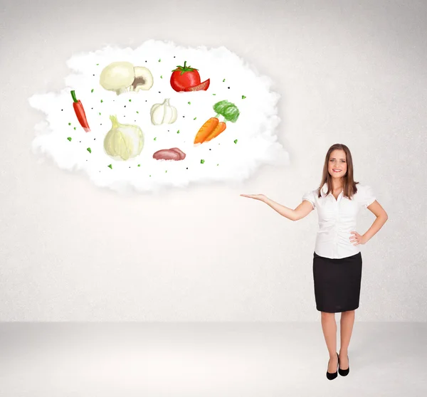 Young girl presenting nutritional cloud with vegetables — Stock Photo, Image