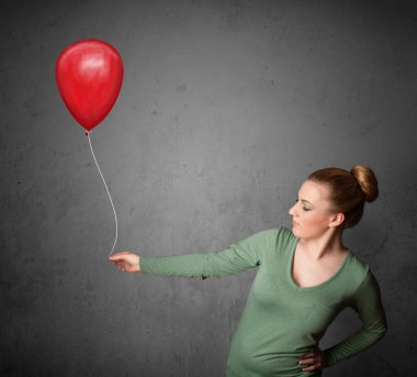 Kırmızı balon tutan kadın