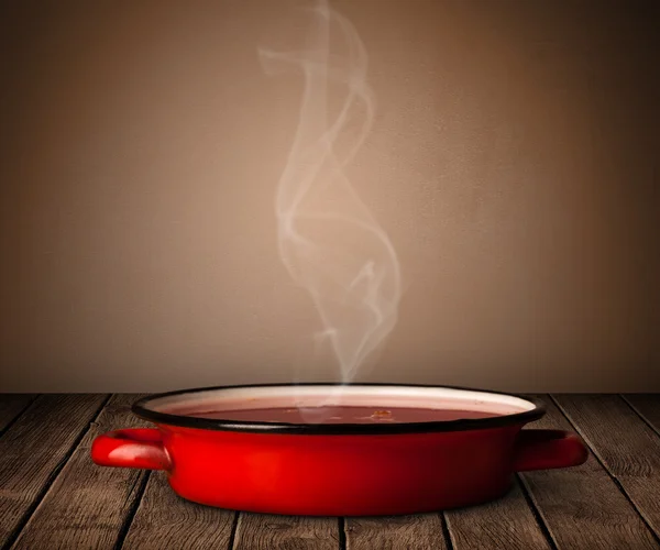 Pot on old wooden table — Stock Photo, Image