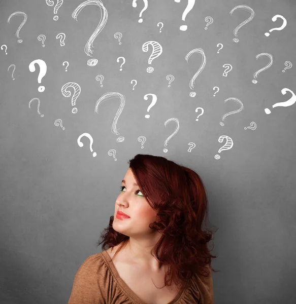 Young woman with question marks above her head — Stock Photo, Image