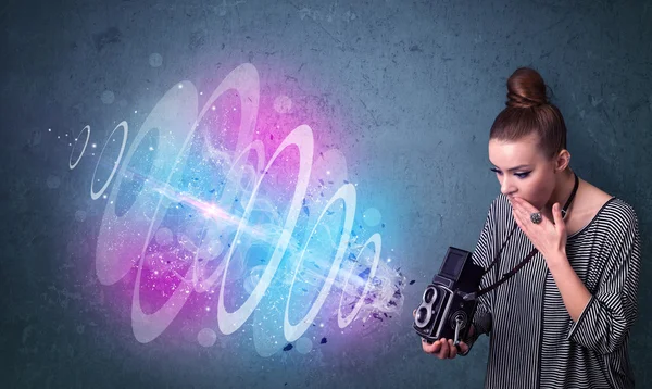 Photographer girl making photos with powerful light beam — Stock Photo, Image