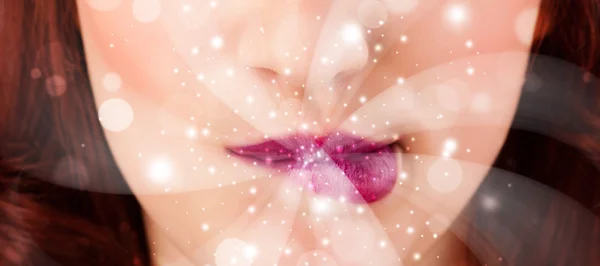 Pretty woman lips blowing abstract white lights — Stock Photo, Image