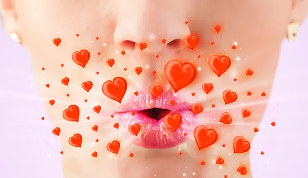Pretty lady lips with lovely red hearts — Stock Photo, Image
