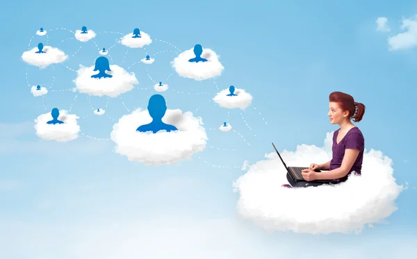 Young woman sitting in cloud with laptop — Stock Photo, Image