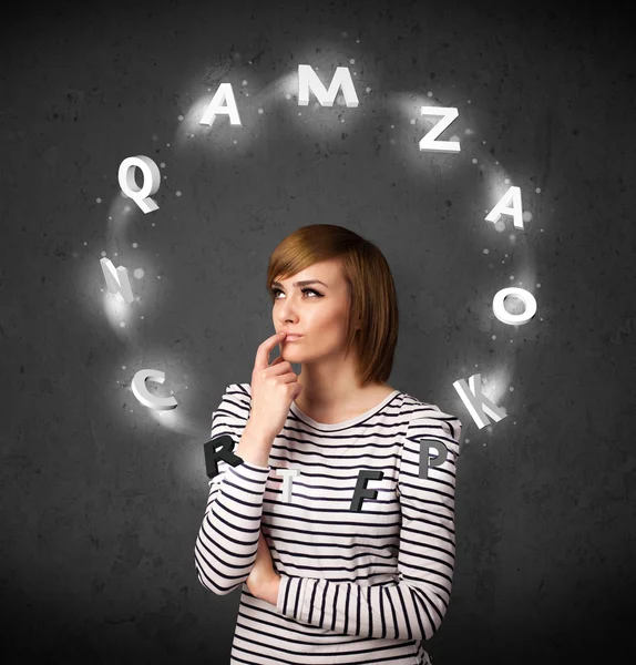 Young woman thinking with letter circulation around her head — Stock Photo, Image