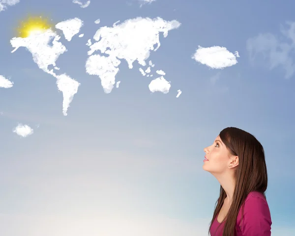 Young girl looking at world clouds and sun on blue sky — Stock Photo, Image