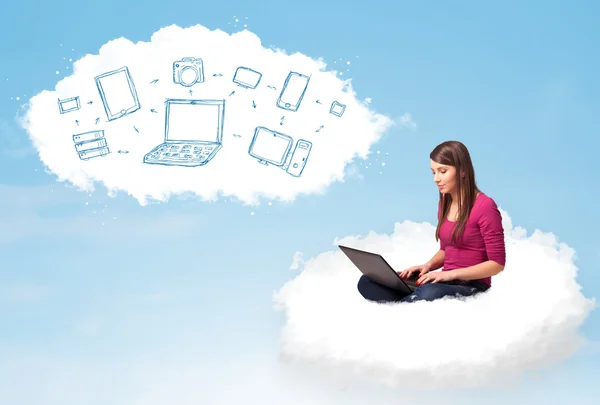 Young woman sitting in cloud with laptop — Stock Photo, Image