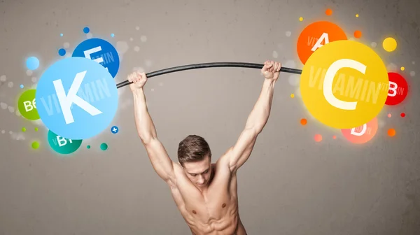 Uomo muscolare sollevamento pesi vitaminici colorati — Foto Stock