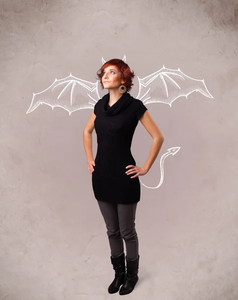 Young girl with devil horns and wings drawing — Stock Photo, Image