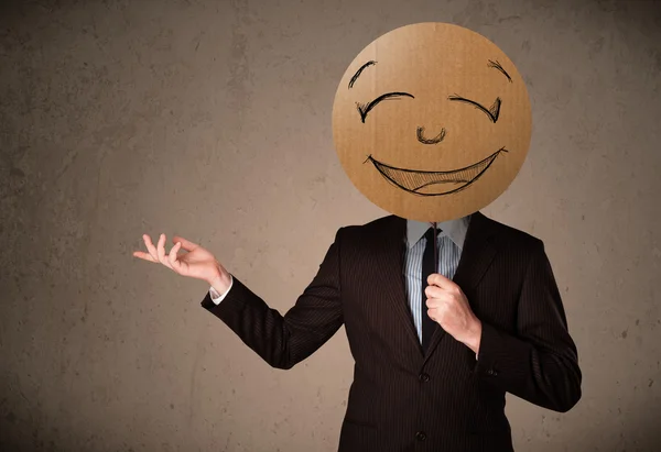 Businessman holding a smiley face board — Stock Photo, Image